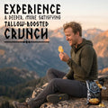 A person sitting outside in the mountains enjoying some Norse Roots beef tallow potato chips.